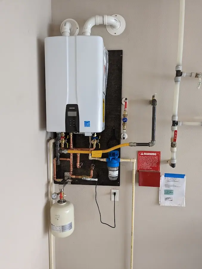 Professional plumber installing copper piping in a Berthoud home